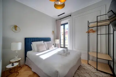 a bedroom with a bed with a teddy bear on it at REF 1393 - Cannes Center - Apartment for rent in Cannes