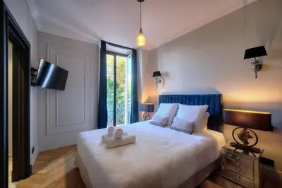a bedroom with a bed with two teddy bears on it at REF 1393 - Cannes Center - Apartment for rent in Cannes