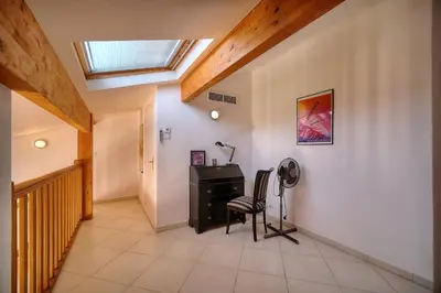 a hallway with a desk and a chair and a skylight at REF 1766 - Cannes Center - Apartment for rent in Cannes