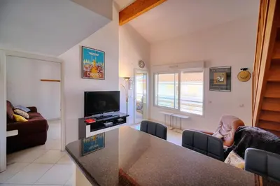 a living room with a kitchen and a living room with a tv at REF 1766 - Cannes Center - Apartment for rent in Cannes