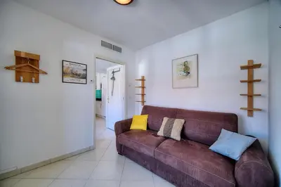 a living room with a brown leather couch at REF 1766 - Cannes Center - Apartment for rent in Cannes