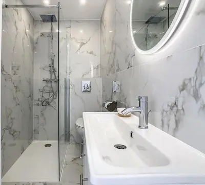 a white bathroom with a sink and a shower at REF 1769 - Cannes - Sea view penthouse for rent in Cannes