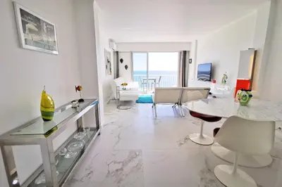 a large white living room with a table and chairs at REF 1769 - Cannes - Sea view penthouse for rent in Cannes