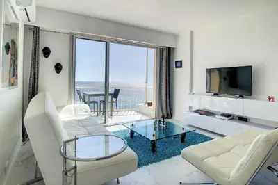 a living room with white furniture and a view of the ocean at REF 1769 - Cannes - Sea view penthouse for rent in Cannes