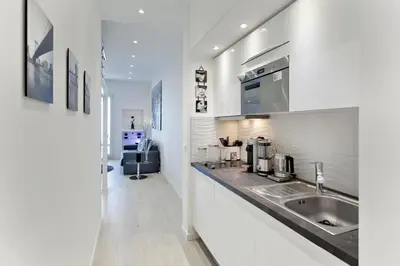 a kitchen with a sink and a counter top at REF 1196 - Cannes Croisette - Sea view apartment for rent in Cannes