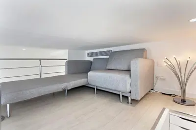 a living room with a couch and a table at REF 1196 - Cannes Croisette - Sea view apartment for rent in Cannes