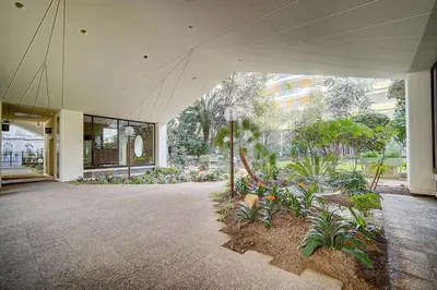 a large building with a courtyard with plants at REF 1389 - Cannes Center - Apartment for rent in Cannes