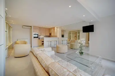 a large living room with a couch and a kitchen at REF 1389 - Cannes Center - Apartment for rent in Cannes