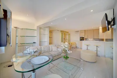 a living room with a couch and a glass table at REF 1389 - Cannes Center - Apartment for rent in Cannes