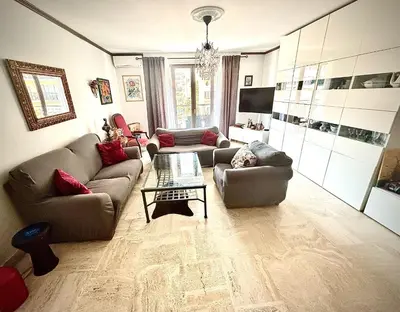 a living room with two couches and a coffee table at Évasion aux Portes de Cannes 100m2 Lumineux 2 Chambres Terrasse et Commerces in Le Cannet