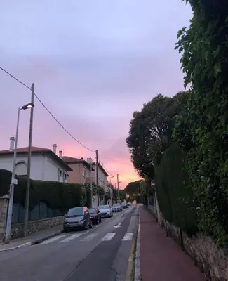 a street with cars parked on the side of the road at Évasion aux Portes de Cannes 100m2 Lumineux 2 Chambres Terrasse et Commerces in Le Cannet