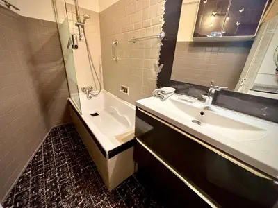 a bathroom with a sink and a shower and a tub at Évasion aux Portes de Cannes 100m2 Lumineux 2 Chambres Terrasse et Commerces in Le Cannet
