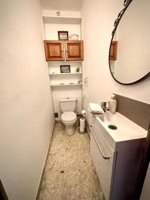 a bathroom with a toilet and a sink and a mirror at Évasion aux Portes de Cannes 100m2 Lumineux 2 Chambres Terrasse et Commerces in Le Cannet