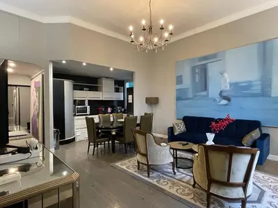 a living room with a couch and a dining room at Luxury 2-floor Flat minutes walk to Croisette and City Center in Cannes