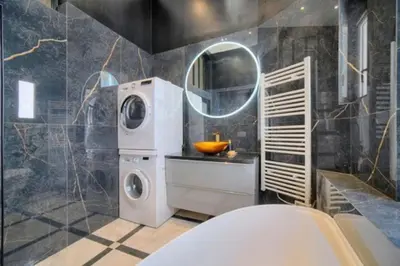 a bathroom with a washing machine and a washer at Luxury 2-floor Flat minutes walk to Croisette and City Center in Cannes
