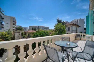 a balcony with a table and chairs on a balcony at Luxury 2-floor Flat minutes walk to Croisette and City Center in Cannes