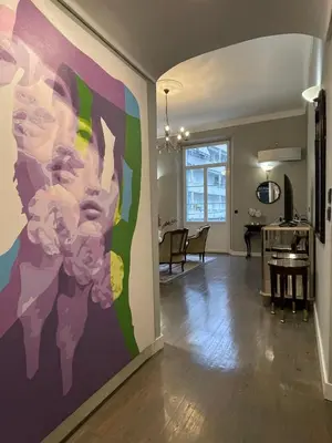 a living room with a large painting on the wall at Luxury 2-floor Flat minutes walk to Croisette and City Center in Cannes