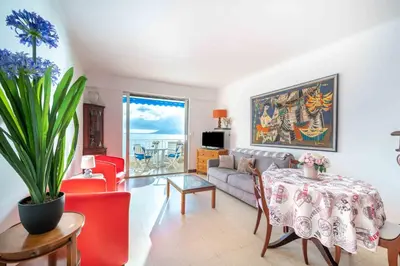 a living room with a couch and a table at Appartement cosy à Cannes - 40 m² avec balcon et vue mer in Cannes