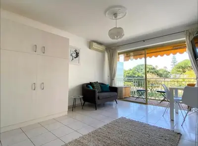 a living room with a couch and a table at Le Bleuette - Festivals 10min - face plages ! in Cannes