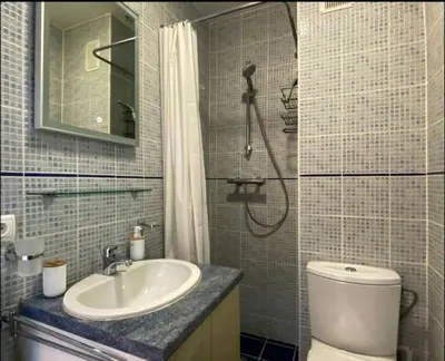 a bathroom with a sink and a shower and a toilet at Le Bleuette - Festivals 10min - face plages ! in Cannes