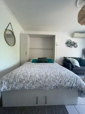 a bedroom with a large bed and a mirror at Le Bleuette - Festivals 10min - face plages ! in Cannes