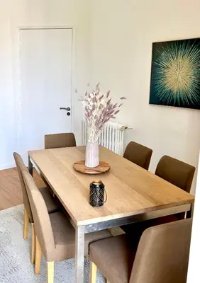 a dining room table with a vase of flowers on it at Top emplacement centre Cannes in Cannes