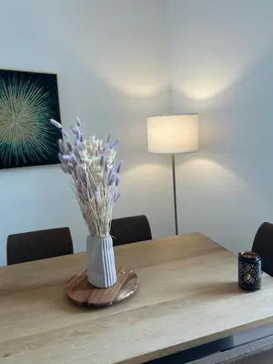 a wooden table with a vase of flowers on it at Top emplacement centre Cannes in Cannes