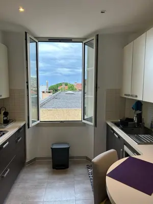 a kitchen with a large window and a table at Top emplacement centre Cannes in Cannes