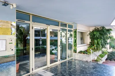 an entrance to a building with glass doors at Les Légendes YourHostHelper in Cannes