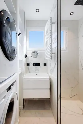 a bathroom with a sink and a washing machine at Les Légendes YourHostHelper in Cannes