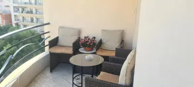 a balcony with two chairs and a table with flowers at STUDIO CANNES STELLAMARE in Cannes