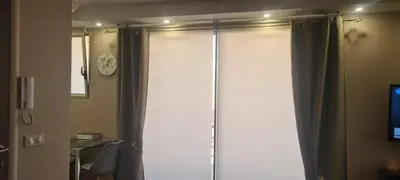 a glass shower door with a curtain in a bathroom at STUDIO CANNES STELLAMARE in Cannes