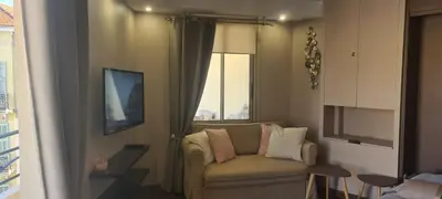a living room with a couch and a window at STUDIO CANNES STELLAMARE in Cannes