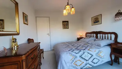 a bedroom with a bed and a dresser and a mirror at Centre Cannes gd 2p terrasse parking 10mn palais plage in Cannes