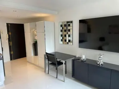 a kitchen with a table and a black chair at Eider croisette in Cannes