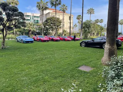 a row of cars parked in a grass field at Eider croisette in Cannes