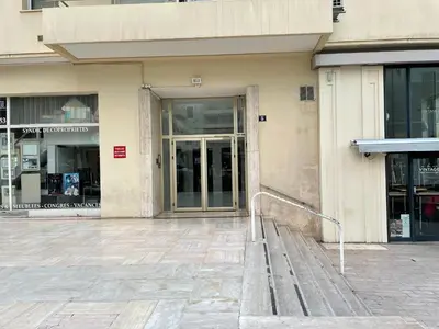 a building with a bench in front of a door at Eider croisette in Cannes