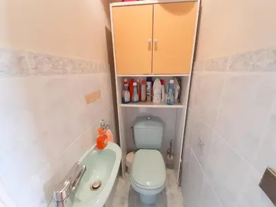 a bathroom with a toilet and a sink and a cabinet at Trident in Cannes