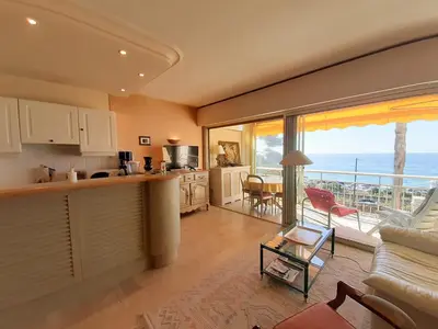 a kitchen and living room with a view of the ocean at Trident in Cannes