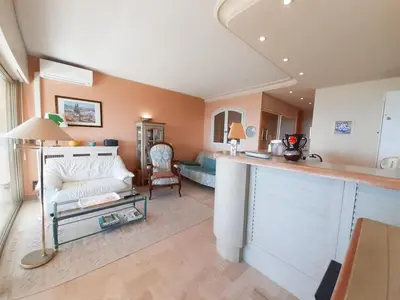 a kitchen and living room with a couch and a table at Trident in Cannes