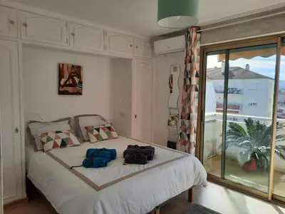 a bedroom with a bed with two bags on it at Appart proche plage avec grand balcon in Cannes