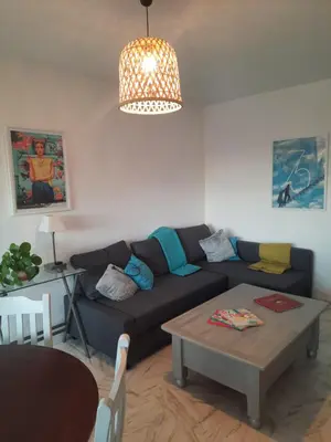 a living room with a couch and a table at Appart proche plage avec grand balcon in Cannes