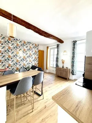 a living room with a dining table and chairs at Les Halles Forville - Palais, plages, wifi, clim in Cannes