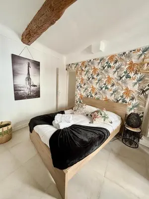 a bedroom with a bed with a picture of a giraffe at Les Halles Forville - Palais, plages, wifi, clim in Cannes