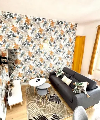 a living room with a couch and a table at Les Halles Forville - Palais, plages, wifi, clim in Cannes