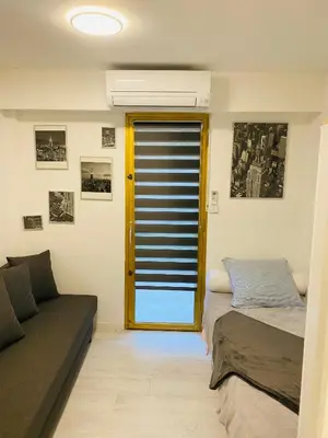 a living room with two beds and a couch at 3 pièces terrasse, jardin in Cannes