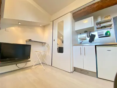 a living room with a television and a refrigerator at Mini Studio - Le Chabaud - Cannes centre in Cannes