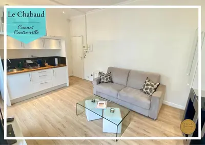 a living room with a couch and a table at Le Chabaud - Cannes centre in Cannes
