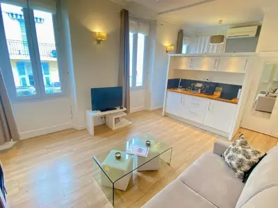 a living room with a couch and a table at Le Chabaud - Cannes centre in Cannes