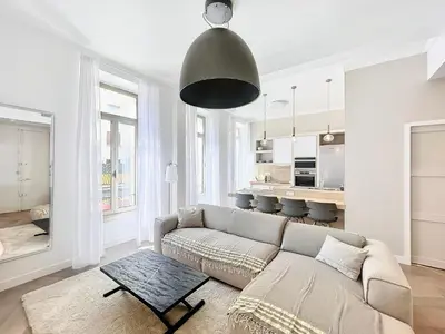 a living room with a couch and a table at Cannes Vidal Rue Antibes SNCF station 2 mn 1 BR new 2024 quiet building hyper center by Olam Properties in Cannes